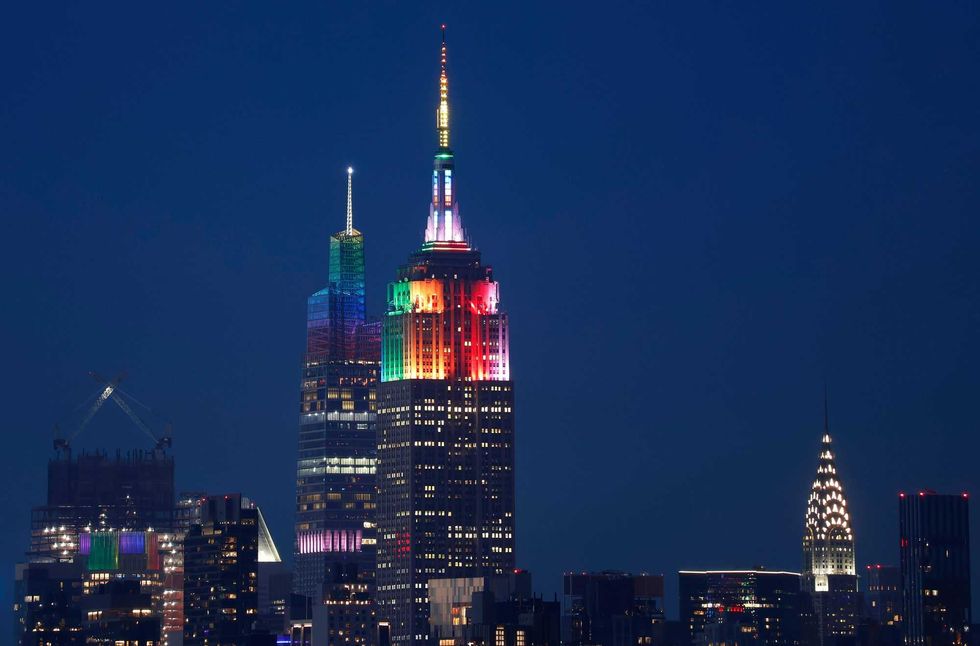 he Empire State Building and One Vanderbilt are illuminated in rainbow colors to mark Pride Day in New York City on June 25 as seen from Jersey City, New Jersey.