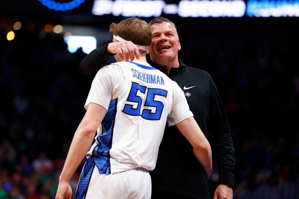Head coach Greg McDermott and Baylor Scheierman #55 of the Creighton Bluejays celebrate as the clock expires in the 72-63 victory over the North Carolina State Wolfpack in the first round of the NCAA Men