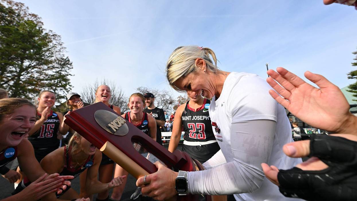 Head coach Hannah Prince celebrates with the Saint Joseph's University field hockey team.
