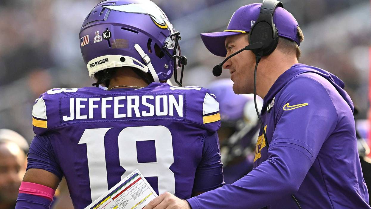 Head coach Kevin O'Connell of the Minnesota Vikings talks with Justin Jefferson #18 in the in the first quarter of a game against the Detroit Lions at U.S. Bank Stadium on October 20, 2024 in Minneapolis, Minnesota.