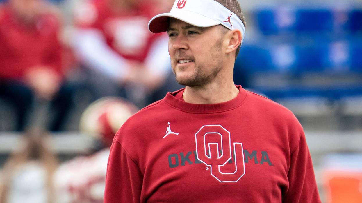 Head coach Lincoln Riley of the Oklahoma Sooners talks to players during warmups before taking on the Kansas Jayhawks at David Booth Kansas Memorial Stadium on October 23, 2021 in Lawrence, Kansas.