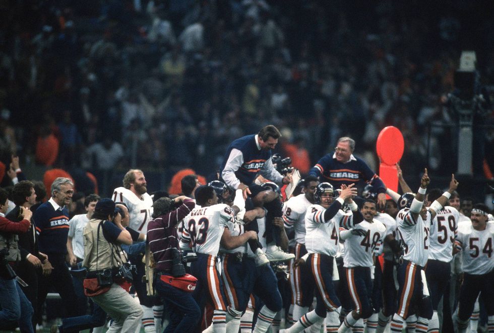 Head Coach Mike Ditka of the Chicago Bears gets carried off