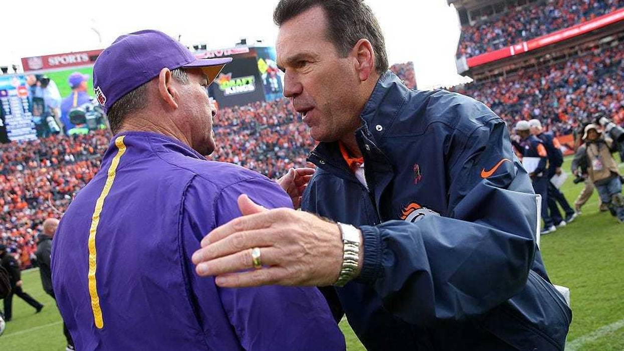 Head coach Mike Zimmer of the Minnesota Vikings and head coach Gary Kubiak of the Denver Broncos meet at midfield following their game at Sports Authority Field at Mile High on October 4, 2015 in Denver, Colorado.