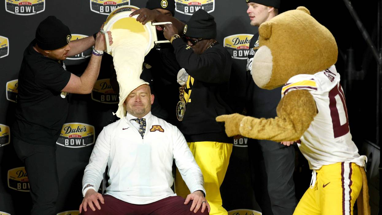 Head coach P.J. Fleck of the Minnesota Golden Gophers gets a mayo bath after winning the Duke's Mayo Bowl against the Virginia Tech Hokies at Bank of America Stadium on January 03, 2025 in Charlotte, North Carolina.