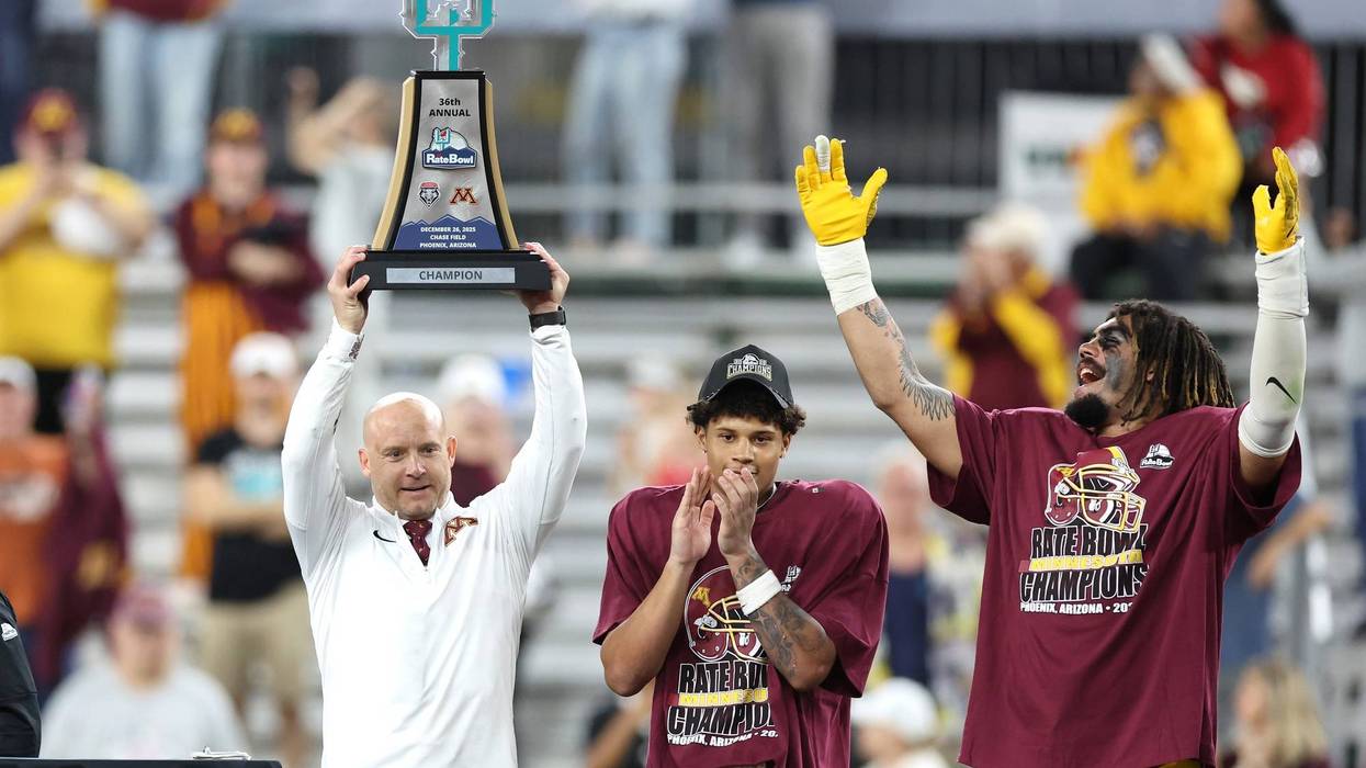 Head coach P.J. Fleck of the Minnesota Golden Gophers holds the championship trophy after beating the New Mexico Lobos 20-17 in overtime of the 2025 Rate Bowl at Chase Field on December 26, 2025 in Phoenix, Arizona.