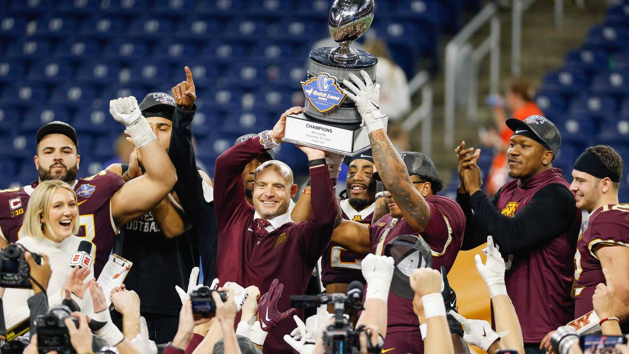 Head coach P.J. Fleck of the Minnesota Golden Gophers holds up the trophy after the Golden Gophers defeated the Bowling Green Falcons, 30-24, in the Quick Lane Bowl at Ford Field on December 26, 2023 in Detroit, Michigan.