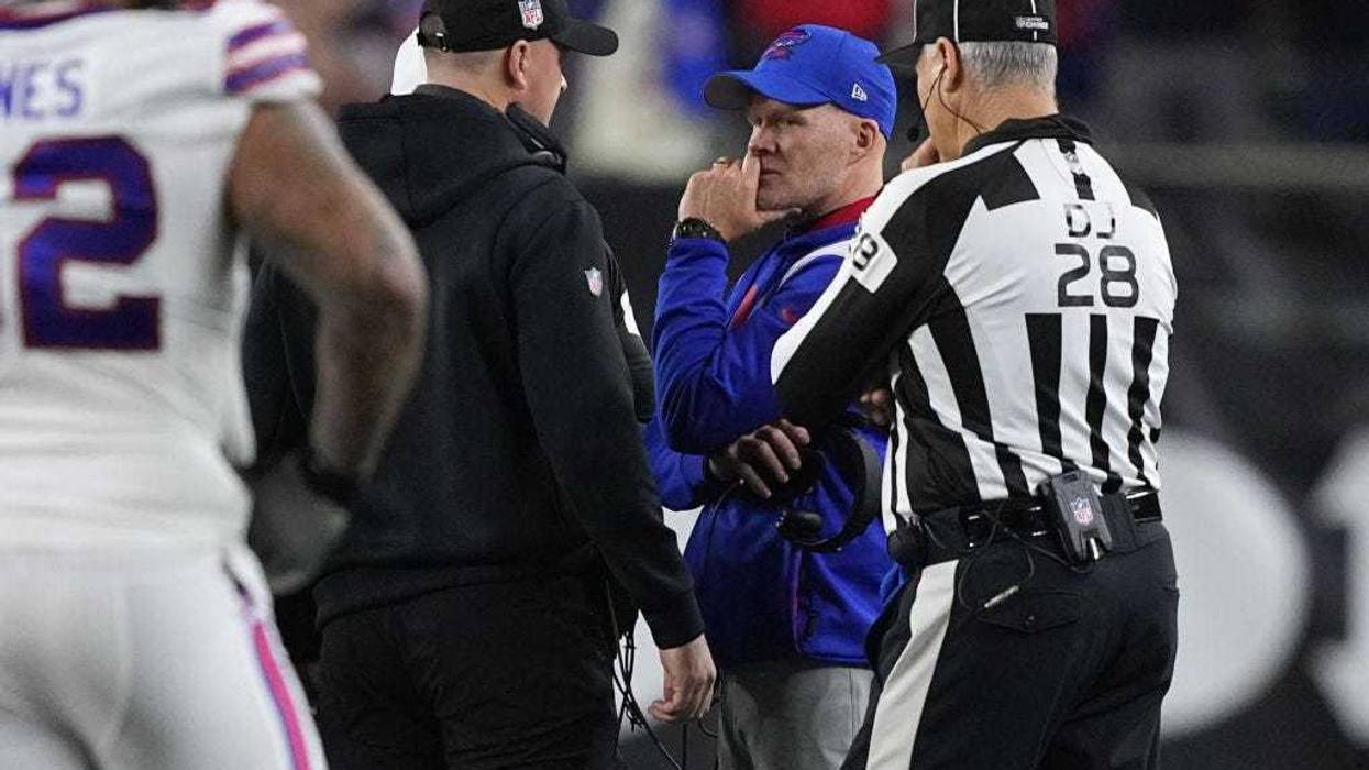 Head coach Sean McDermott of the Buffalo Bills and head coach Zac Taylor of the Cincinnati Bengals speak during the suspension of their game following the injury of Damar Hamlin #3 of the Buffalo Bills at Paycor Stadium