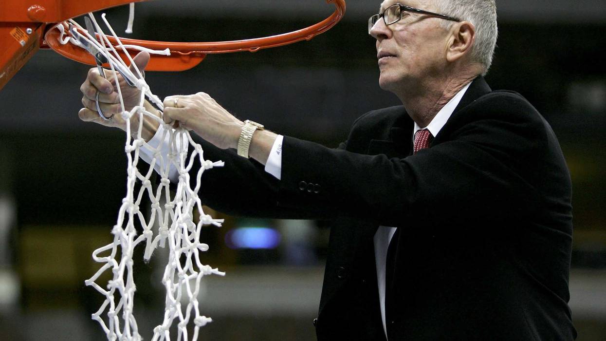 Head coach Steve Fisher of the San Diego State University Aztecs cuts down the net after defeating the Wyoming Cowboys 69-64 in the championship of the Mountain West Conference Basketball Tournament