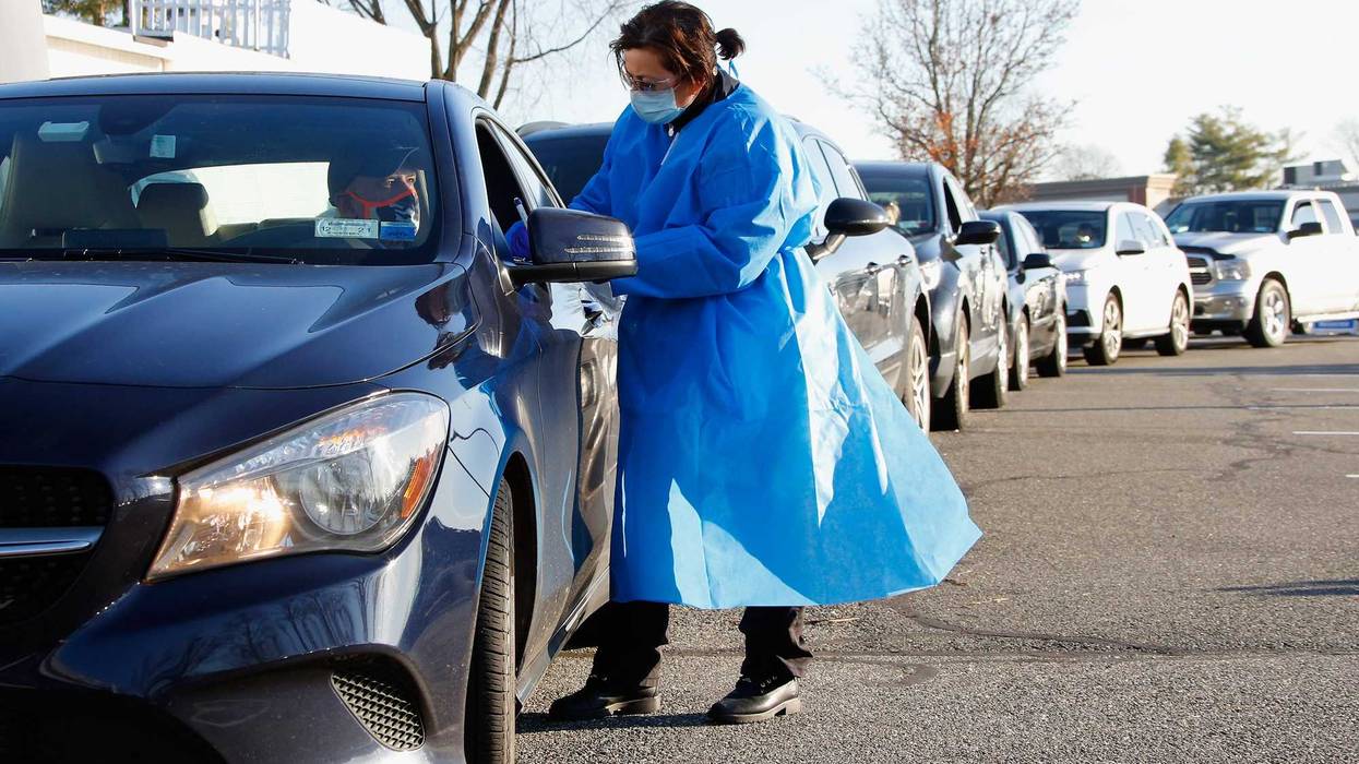 Health care workers tend to patrons who arrive for rapid COVID-19 tests at ProHealth Care on December 03, 2020 in Jericho, New York.