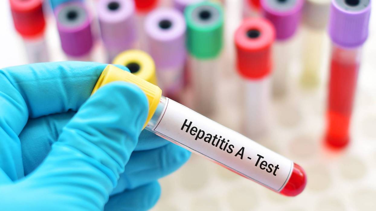 health worker holding blood test vial