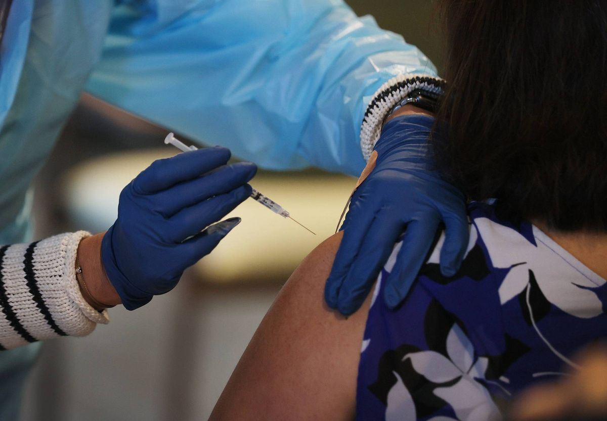 Healthcare worker administers a COVID-19 vaccine at a Florida nursing facility.
