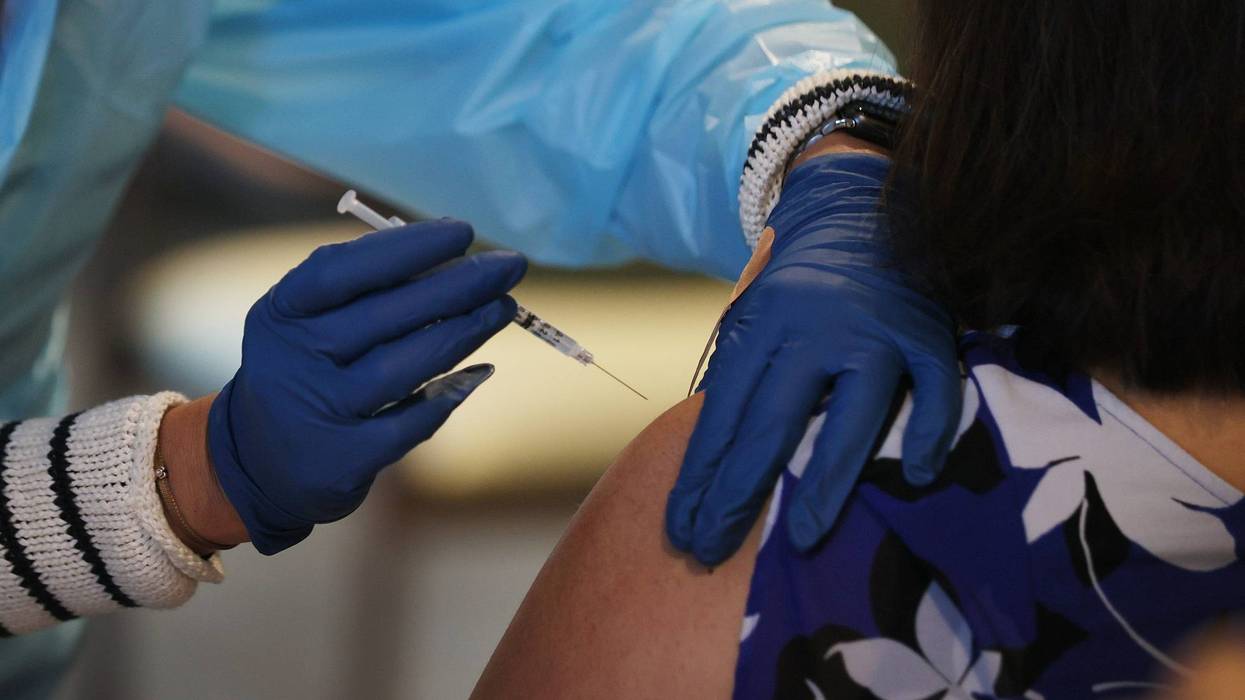 Healthcare worker administers a COVID-19 vaccine at a Florida nursing facility.