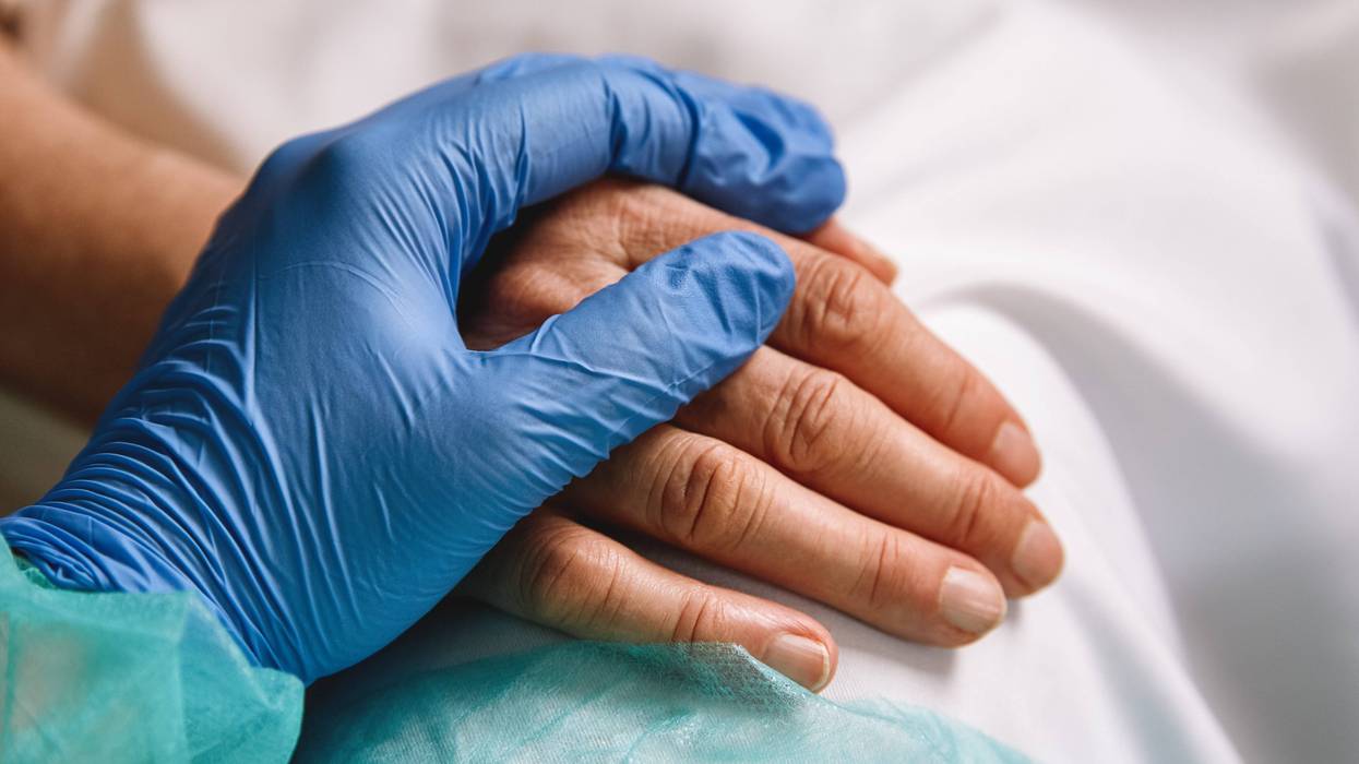 Healthcare worker giving support and love to a patient - stock photo