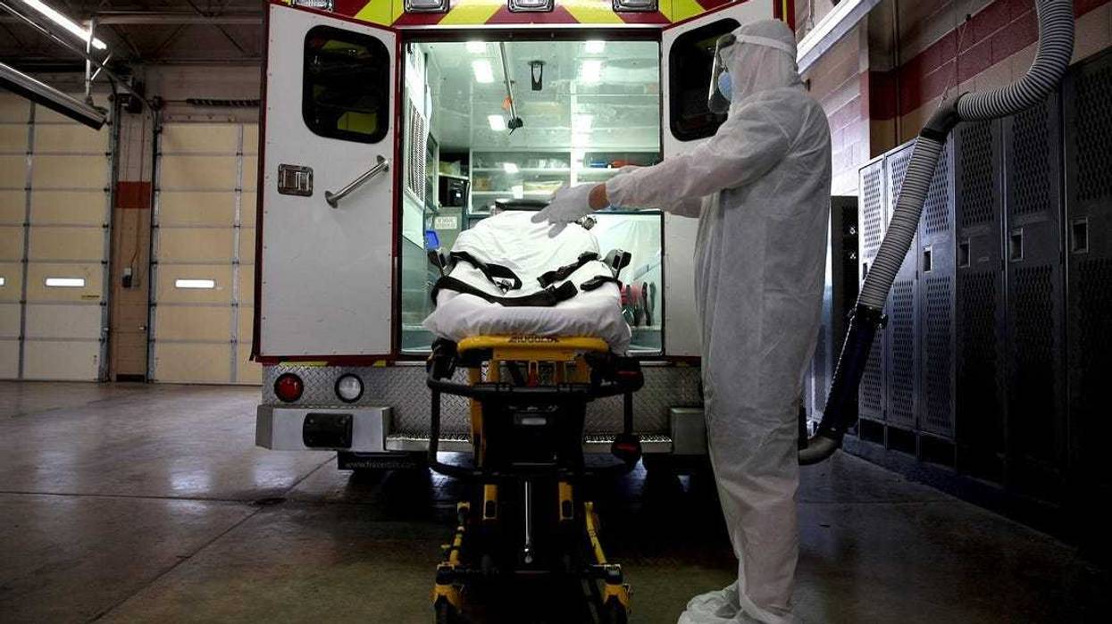 Healthcare worker prepares to pickup a patient with covid-19