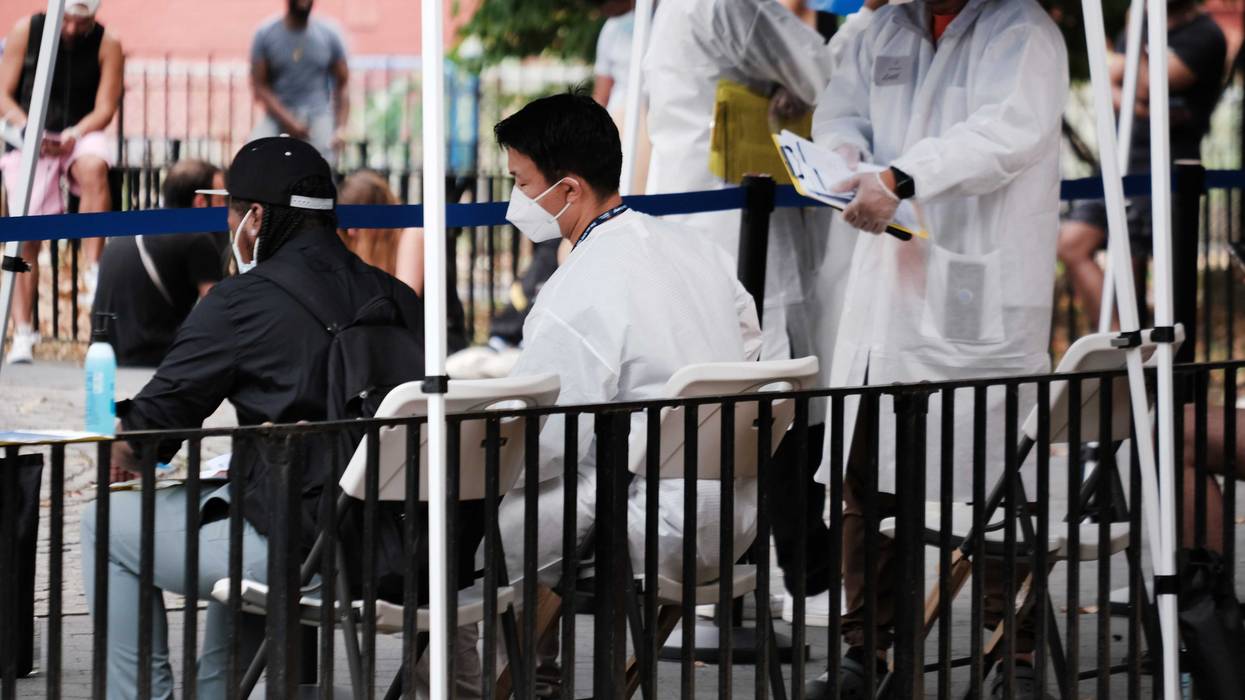 Healthcare workers with New York City Department of Health and Mental Hygiene work at intake tents where individuals are registered to receive the monkeypox vaccine on July 29, 2022 in New York City. The World Health Organization has now declared that the monkeypox outbreak, which continues to grow globally, is a global emergency.