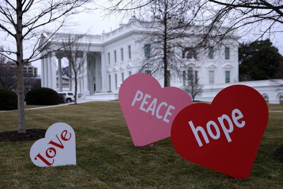 Heart-shape signs with Valentine messages are on display on the North Lawn of the White House February 12, 2021 in Washington, DC. The office of first lady Jill Biden set up the Valentine messages to the country overnight to mark Valentine’s Day. According to a media release, Valentine’s Day has always been one of the favorite holidays of the first lady.