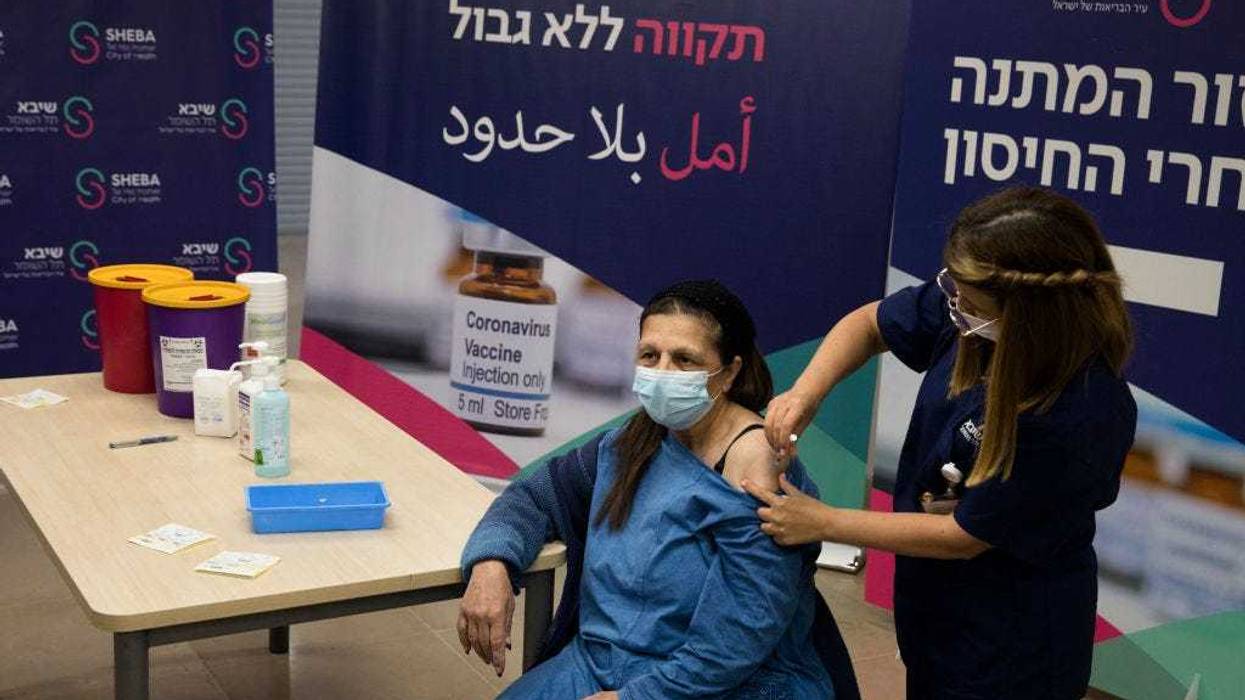 Heart transplant patient, Malka Pe'er receives a fourth dose of coronavirus (COVID-19) disease vaccine on December 31, 2021 in Ramat Gan, Israel. Israel's Health Ministry approves a fourth vaccine dose for people with compromised immune systems. (Photo by Amir Levy/Getty Images)