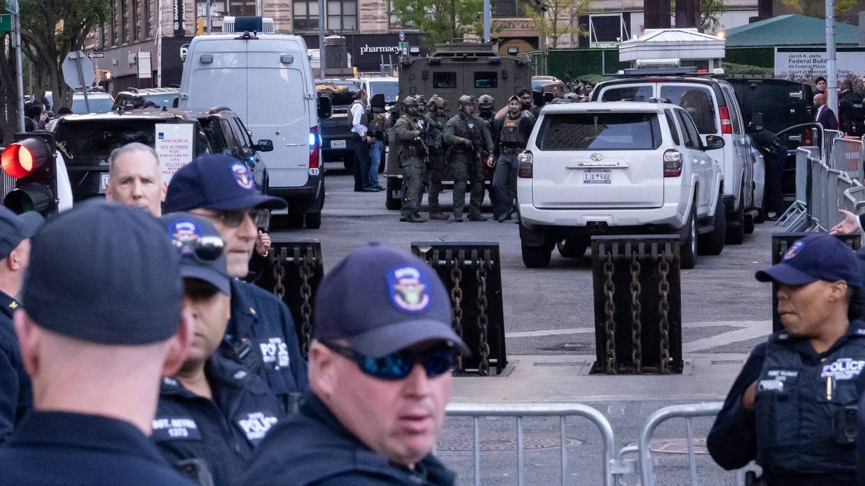 Heavily armed federal agents stand by an armored vehicle as NYPD Strategic Response Group agents stand by outside of 26 Federal Plaza on Oct. 21, 2025 in New York.
