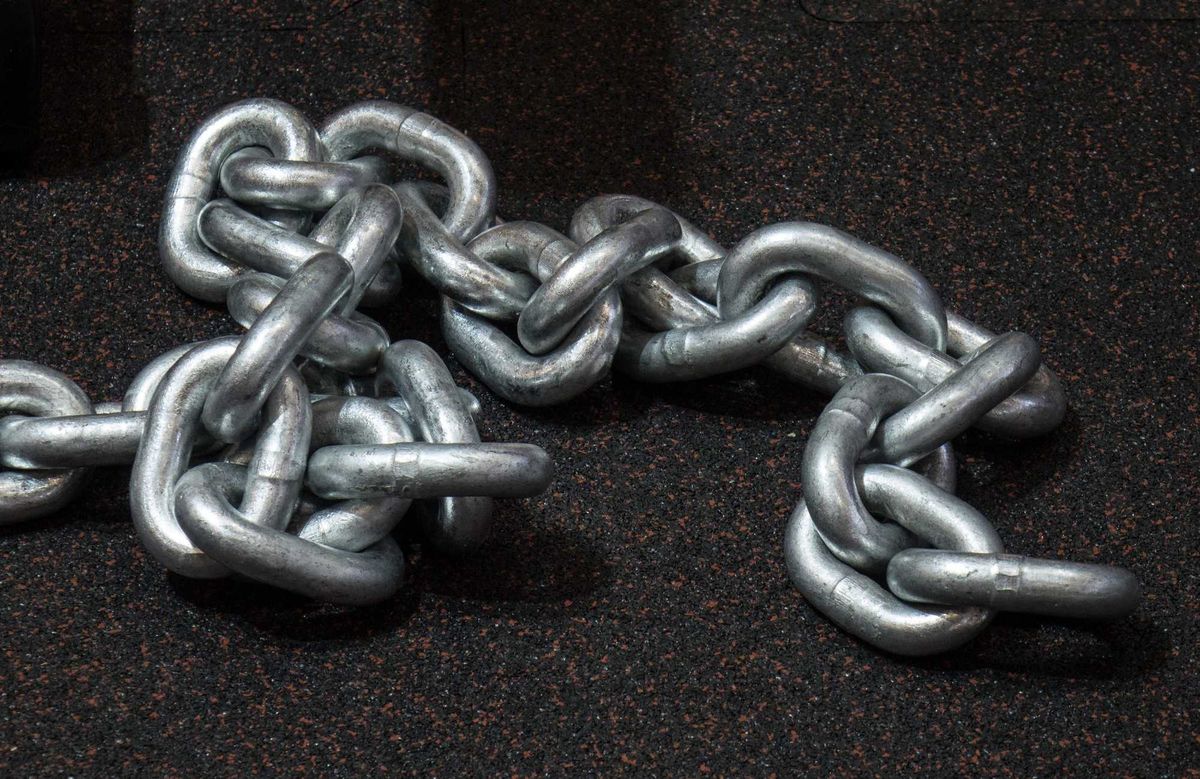 Heavy metal chain laying on the floor.