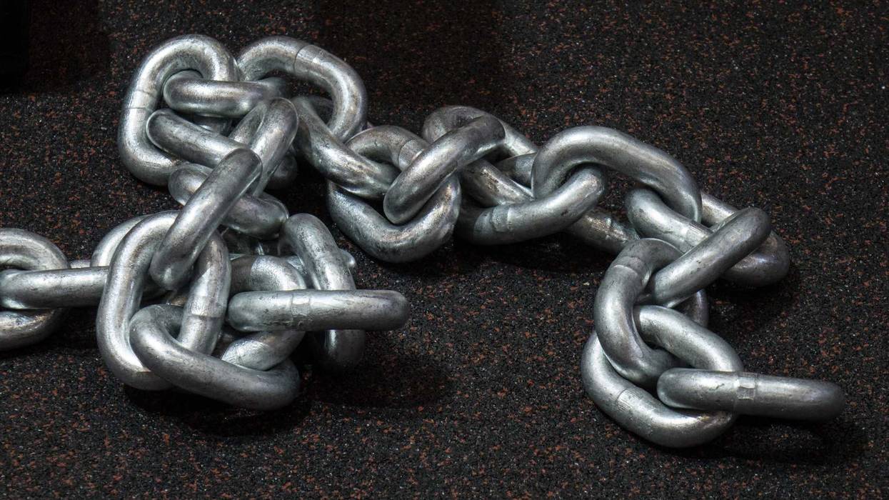 Heavy metal chain laying on the floor.