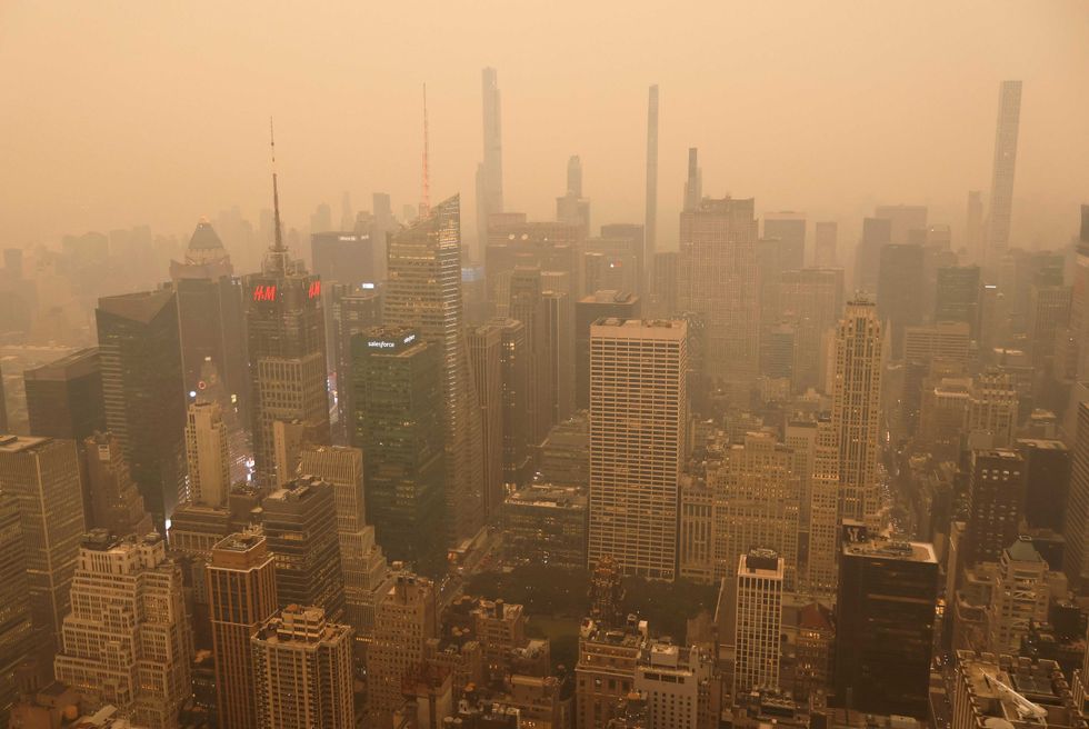 Heavy smoke shrouds buildings around Times Square in a view looking north from the Empire State Building as the sun sets on June 6, 2023, in New York City