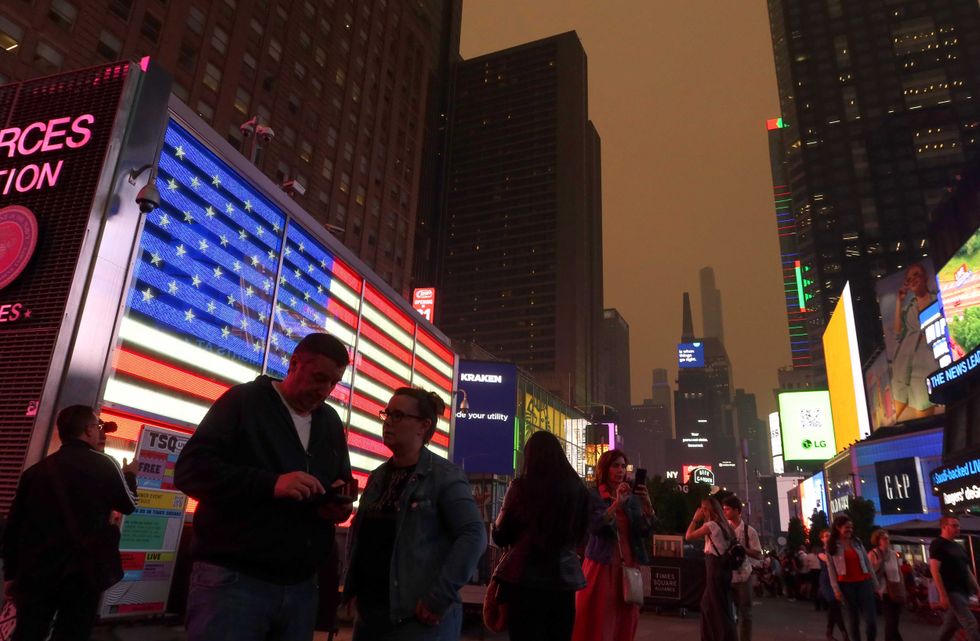 Heavy smoke shrouds buildings in Times Square as the sun sets on June 6, 2023, in New York City