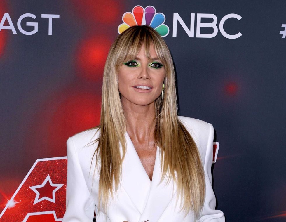 Heidi Klum, 48, puts her supermodel legs on display in short white blazer dress