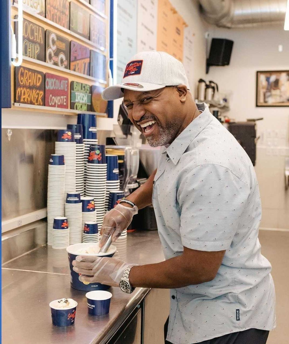 Henry Lake serving up scoops of "Henry by the Lake" ice cream at Sebastian Joe's to help benefit the University of Minnesota's Masonic Children's Hospital.