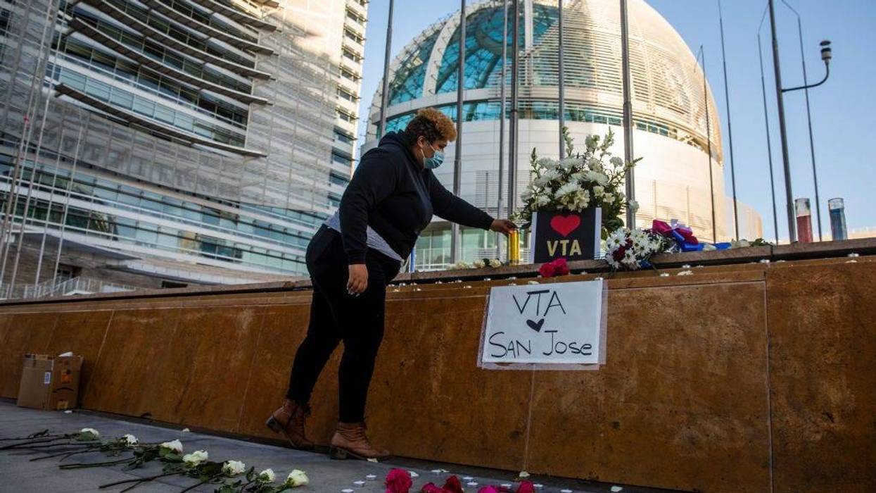HERO Tent President Kiana Simmons places a candle at a vigil organized by her group following the mass shooting at the Valley Transportation Authority (VTA) light-rail yard, outside City Hall on May 26, 2021 in San Jose, California.