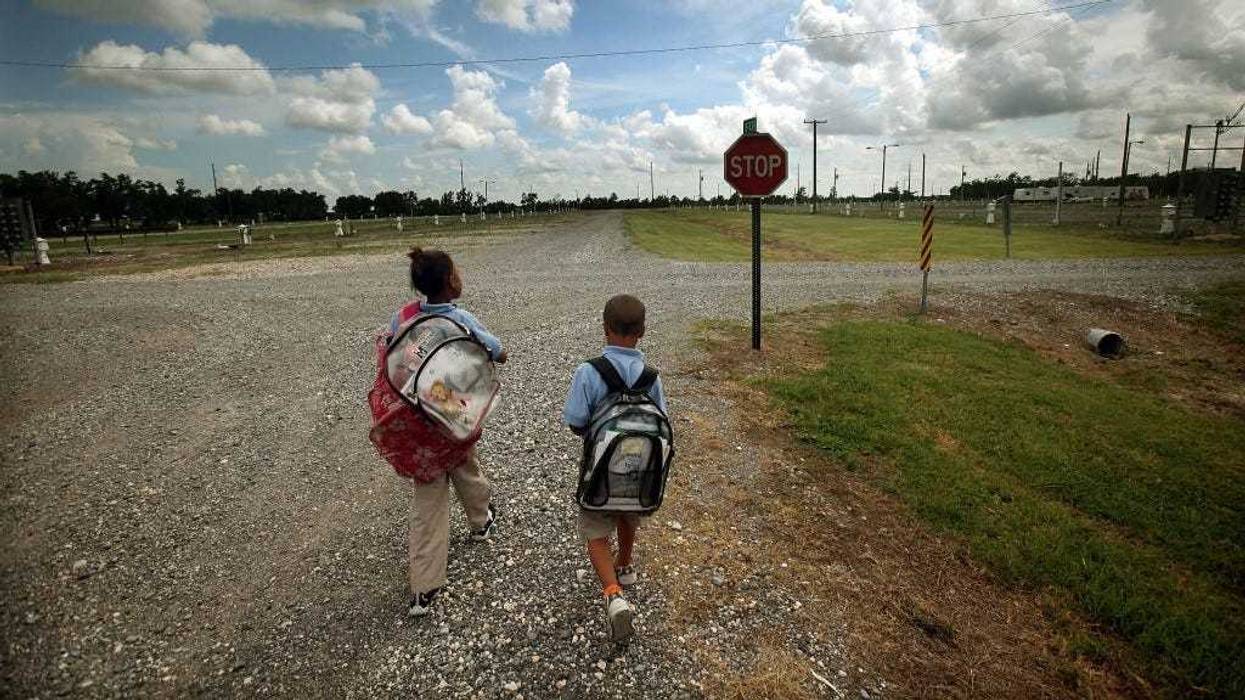 Herschel Barthelemy and sister Jalinh Vasquez walk home in the FEMA Diamond trailer park after getting dropped off by the school bus May 14, 2009 in Port Sulphur, Louisiana.