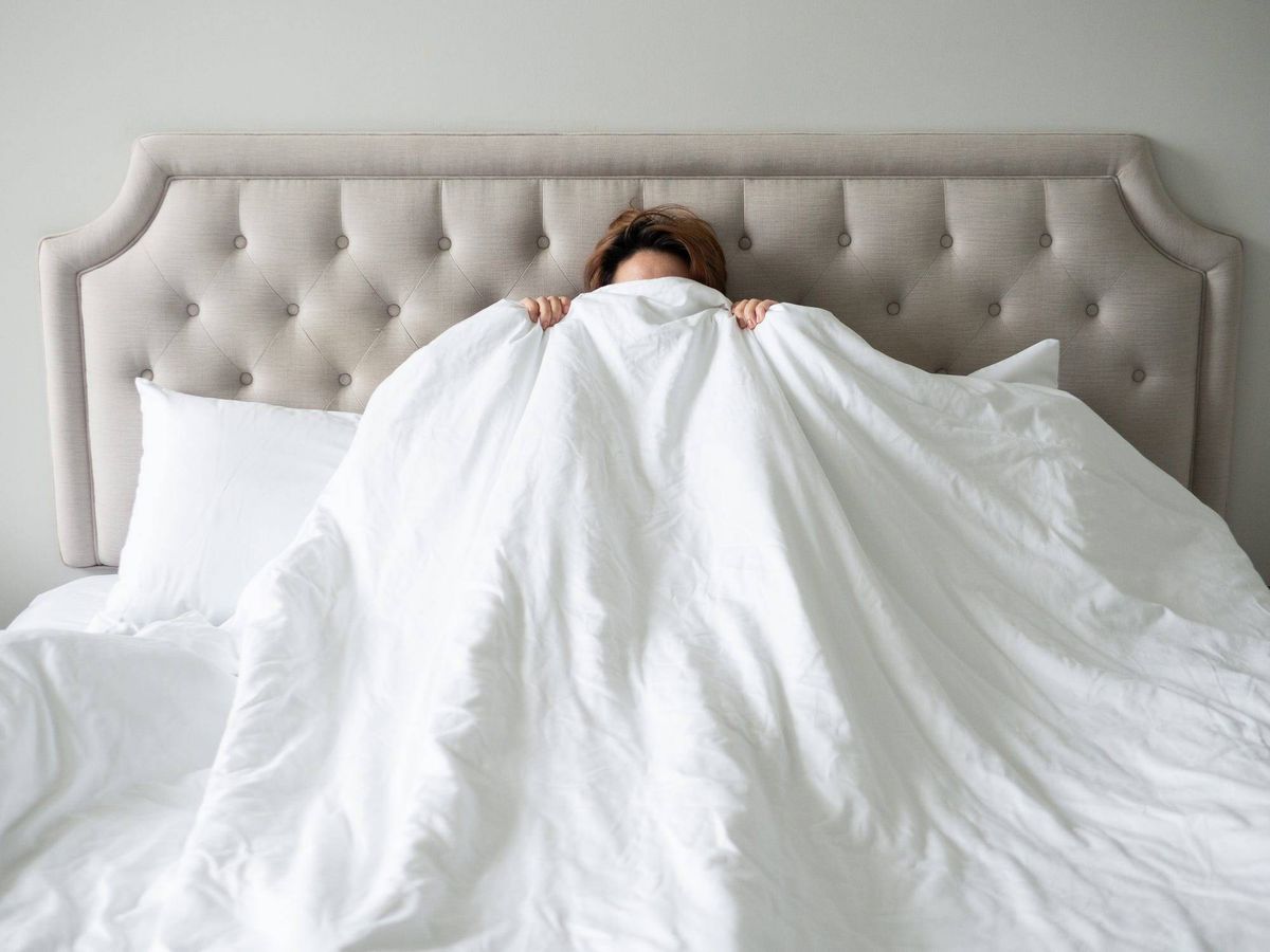 hiding behind bed covers