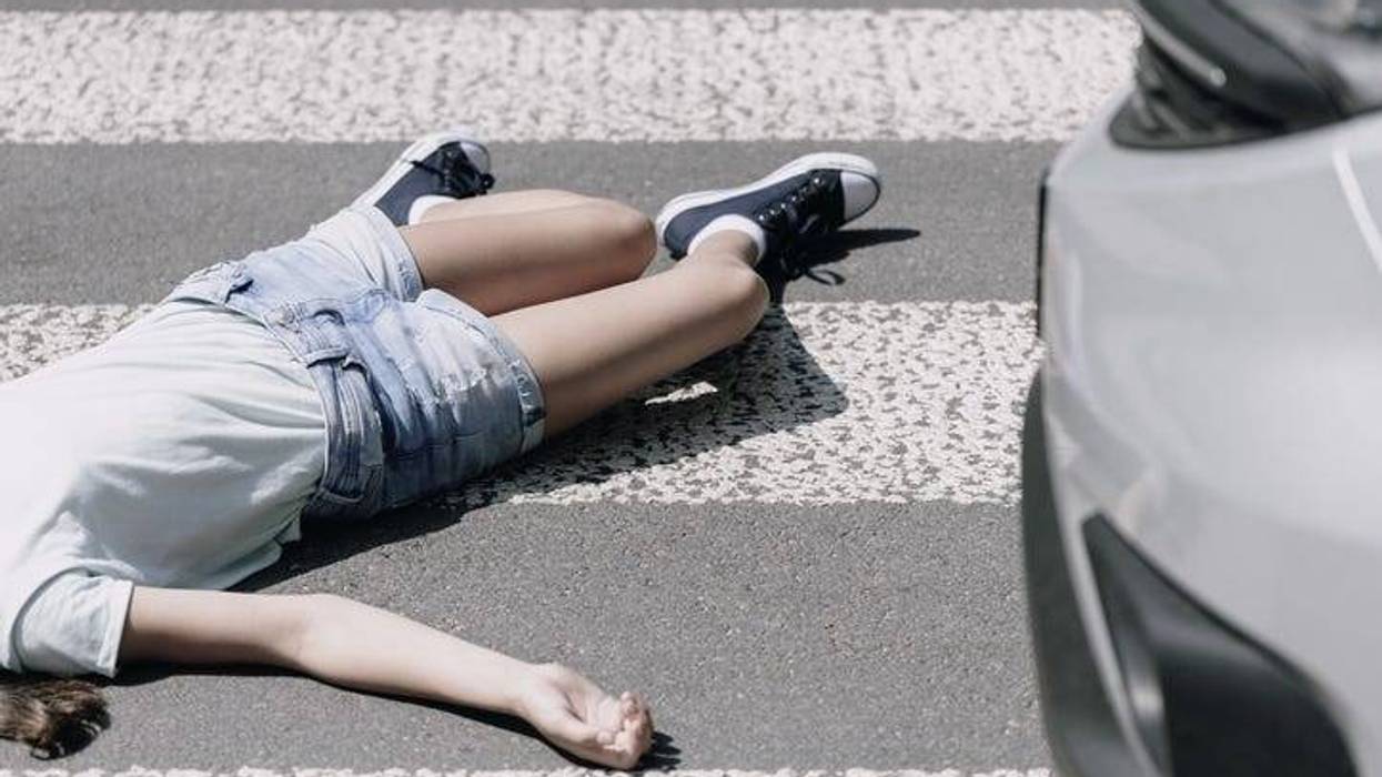 High angle on a child on a crosswalk hit by a car