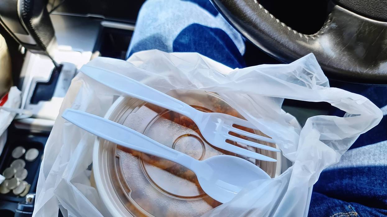 High Angle View of Food in Bowl in Car With Plastic Fork and Spoon on Lid