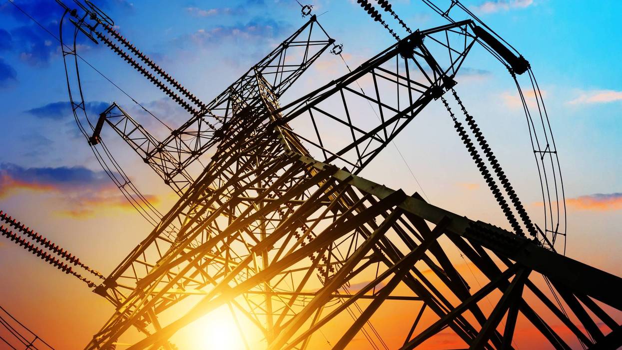 High voltage tower with sun streaming through
