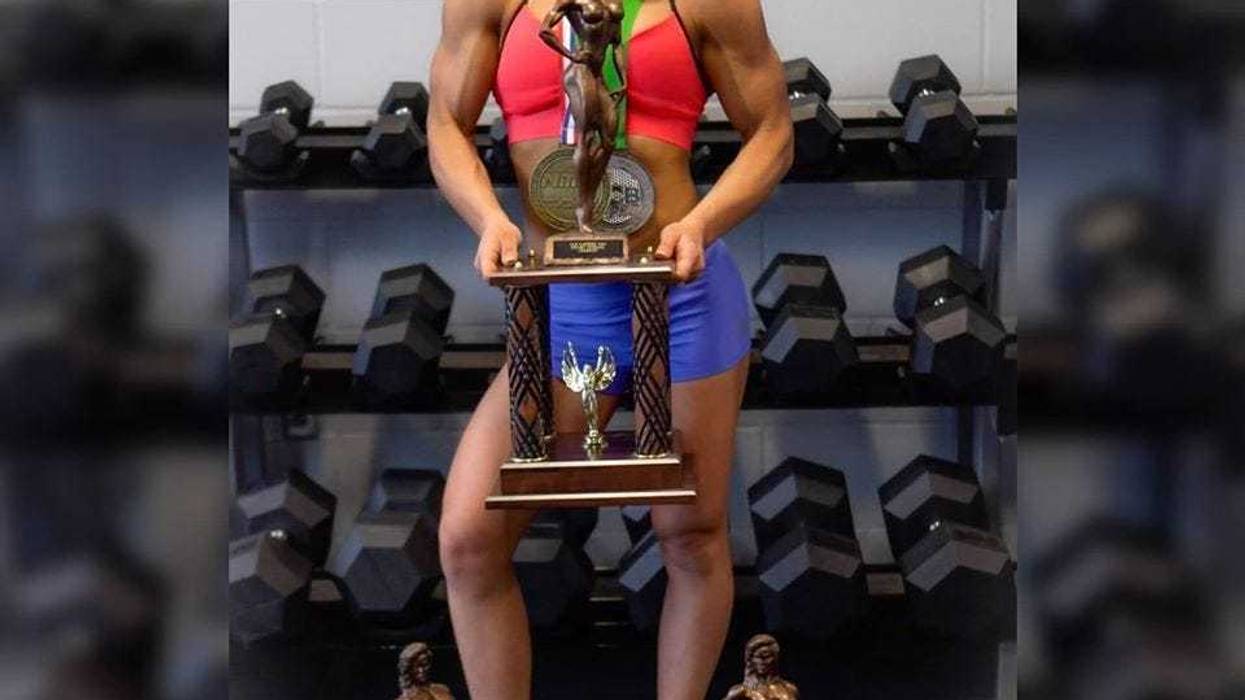Hillery Dennies, a professional bodybuilder from Akron, poses with a trophy. (Photo courtesy of Hillery Dennies)