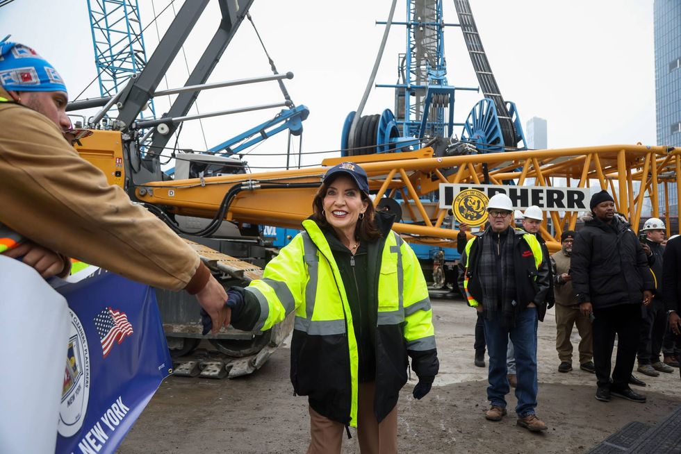 Hochul, center, greets workers at the Gateway construction site in New York on Tuesday.