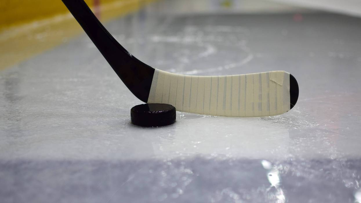 Hockey stick and puck on an ice rink