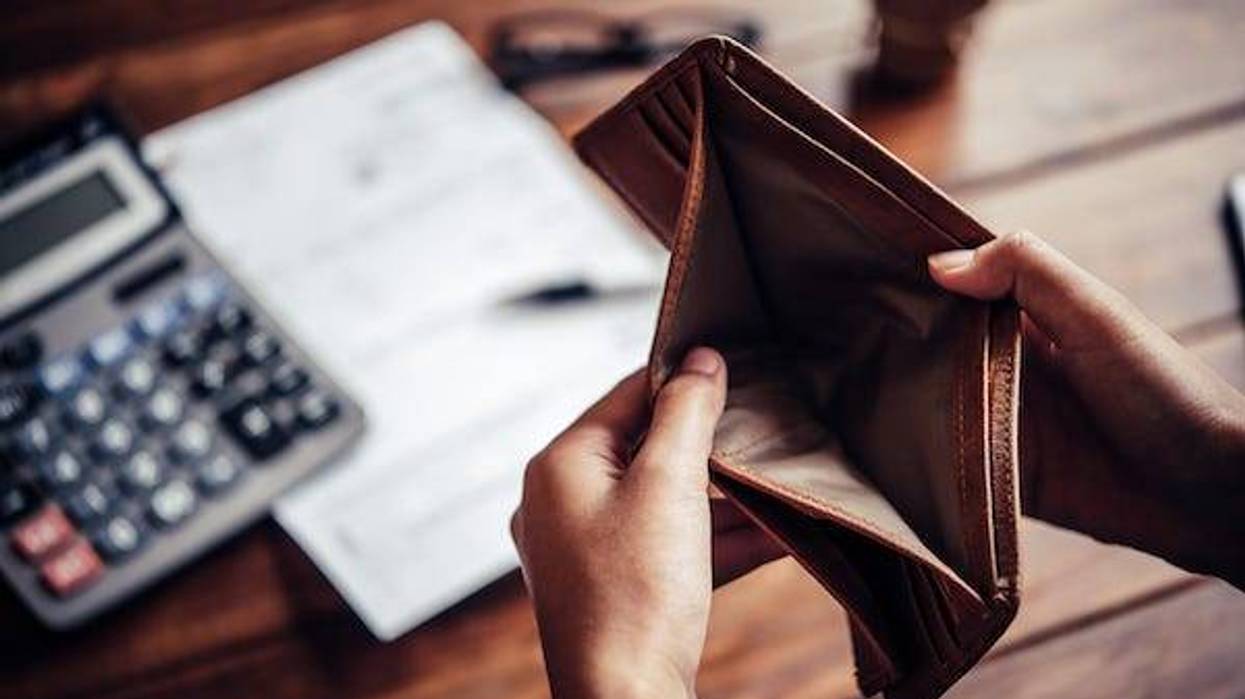 Holding empty wallet open while doing finances