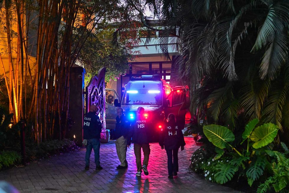 Homeland Security Investigation agents are seen at the entrance of music mogul Sean "Diddy" Combs