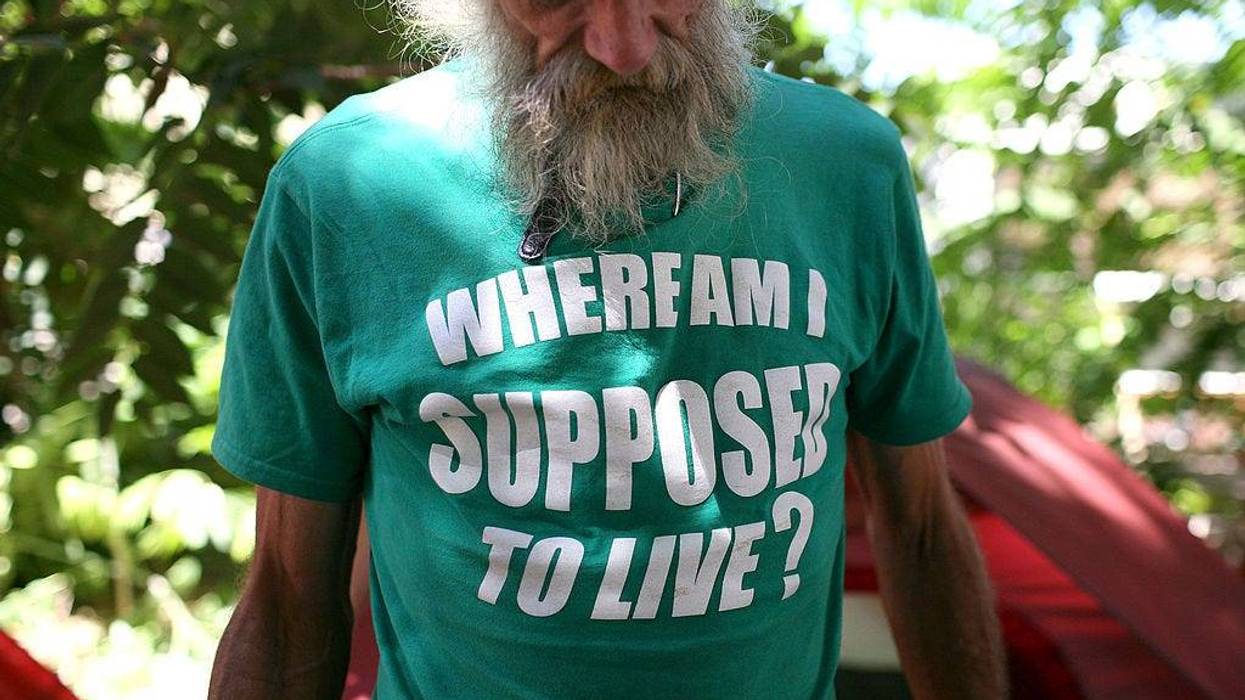 Homeless man John Kraintz stands in front of his tent in a "Safe Ground" encampment August 26, 2009 in Sacramento, California.