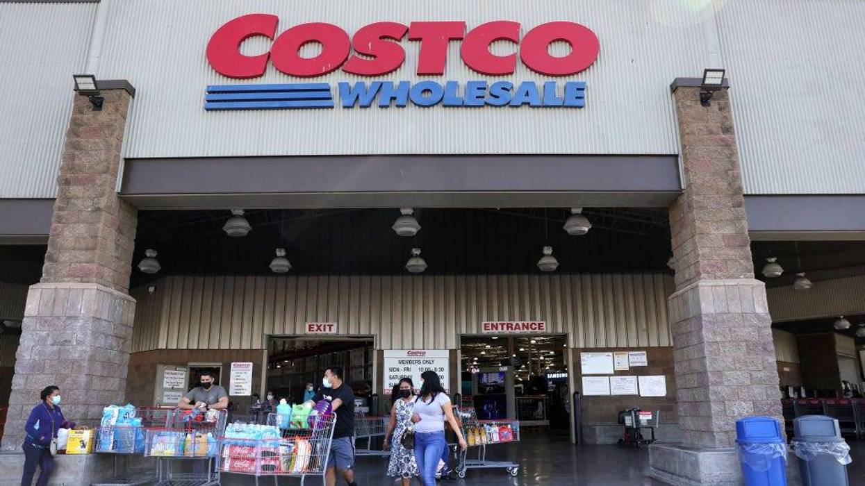 hoppers walk in front of a Costco store on February 25, 2021 in Inglewood, Calif.