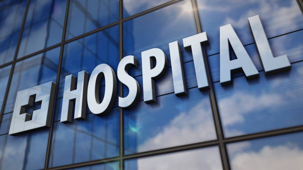 Hospital glass building. Mirrored sky and city on modern facade