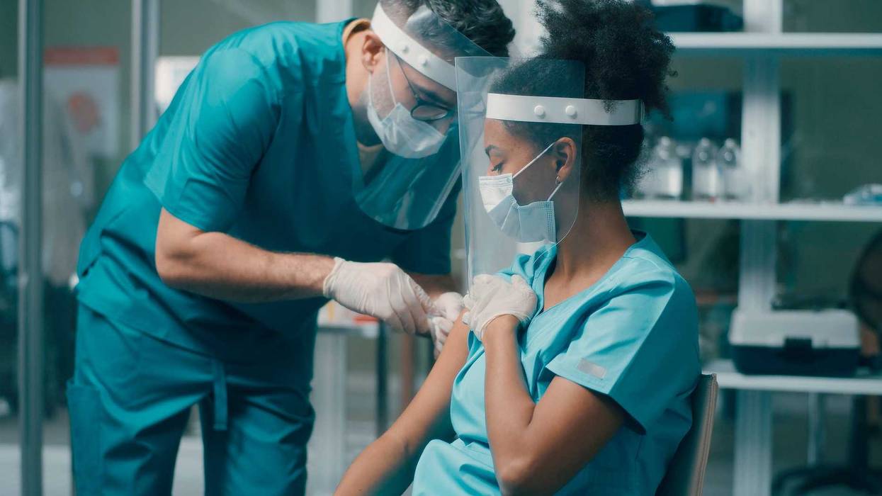 Hospital worker getting vaccinated stock photo.