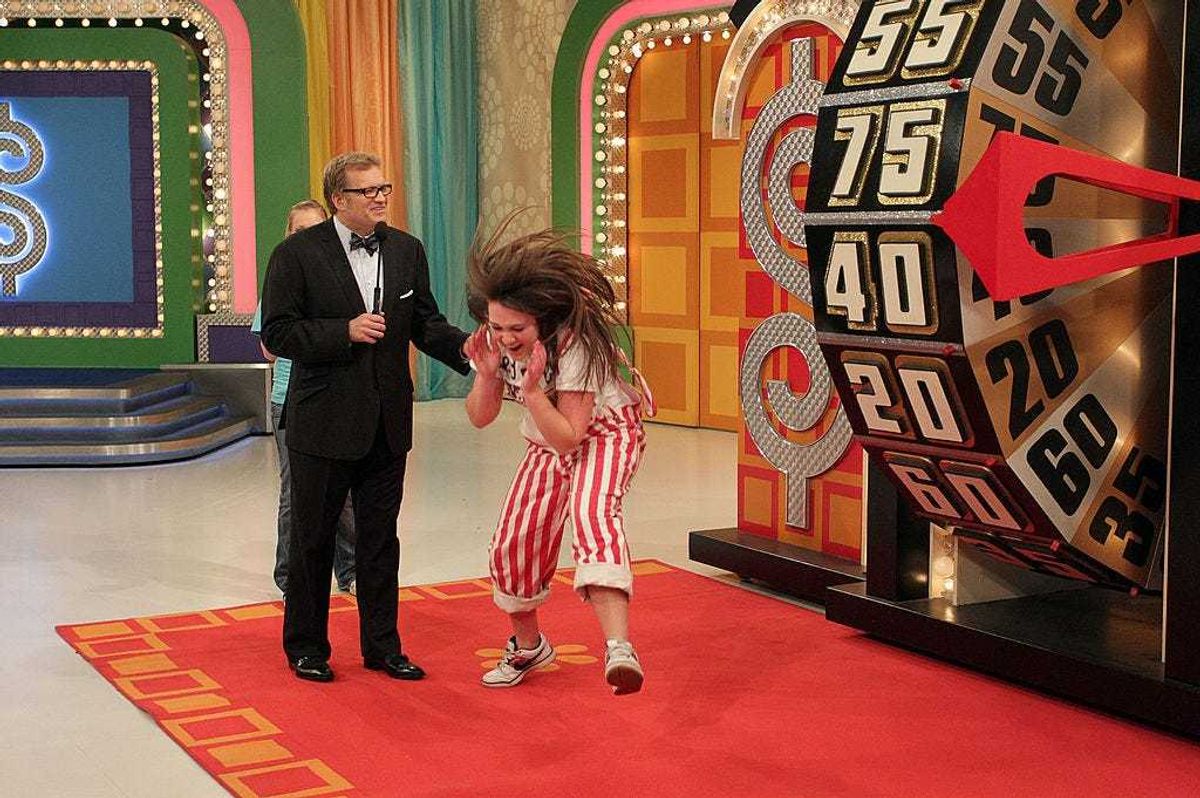 Host Drew Carey (L) watches a contestant react during the People's Choice Awards Showcase on "The Price Is Right" television show on January 3, 2011 in Studio City, California.