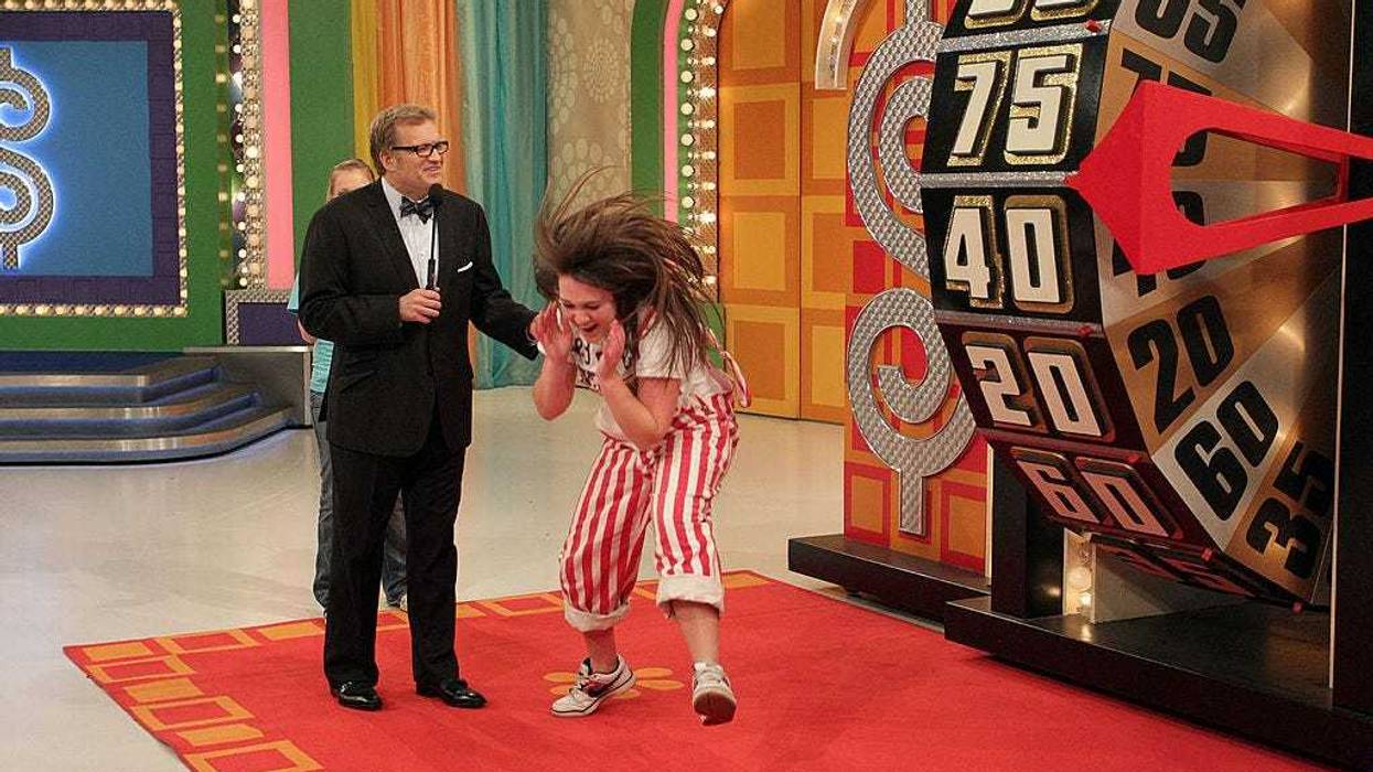Host Drew Carey (L) watches a contestant react during the People's Choice Awards Showcase on "The Price Is Right" television show on January 3, 2011 in Studio City, California.