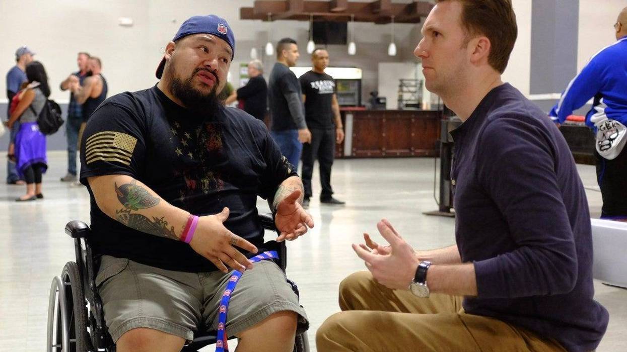 Host Jordan Klepper (right) speaks with a vet at a Valhalla Club event in Killeen, Texas