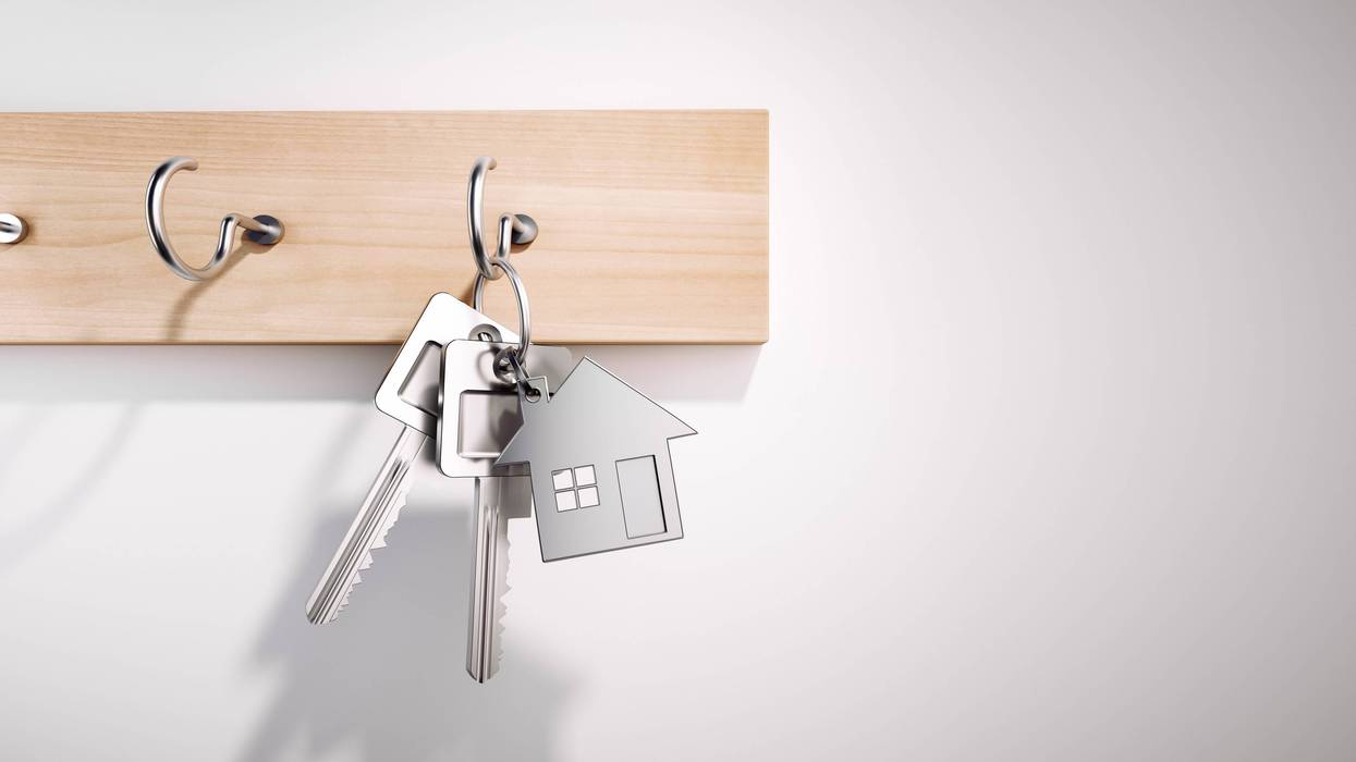 House Keys with Key Ring hanging on wooden Board