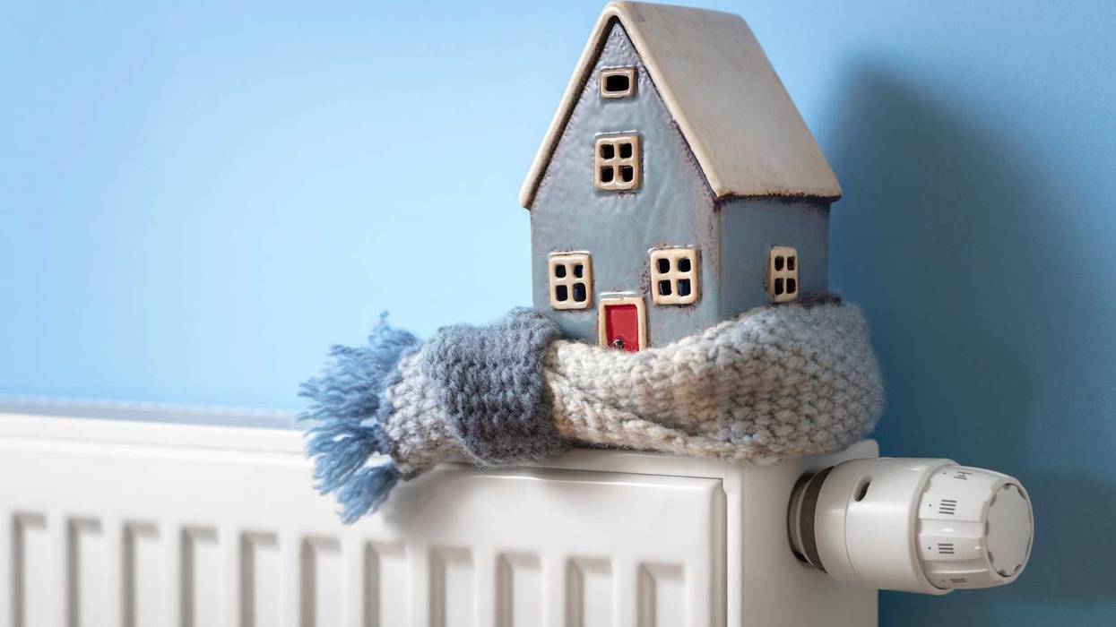 House model wrapped in scarf on a radiator.