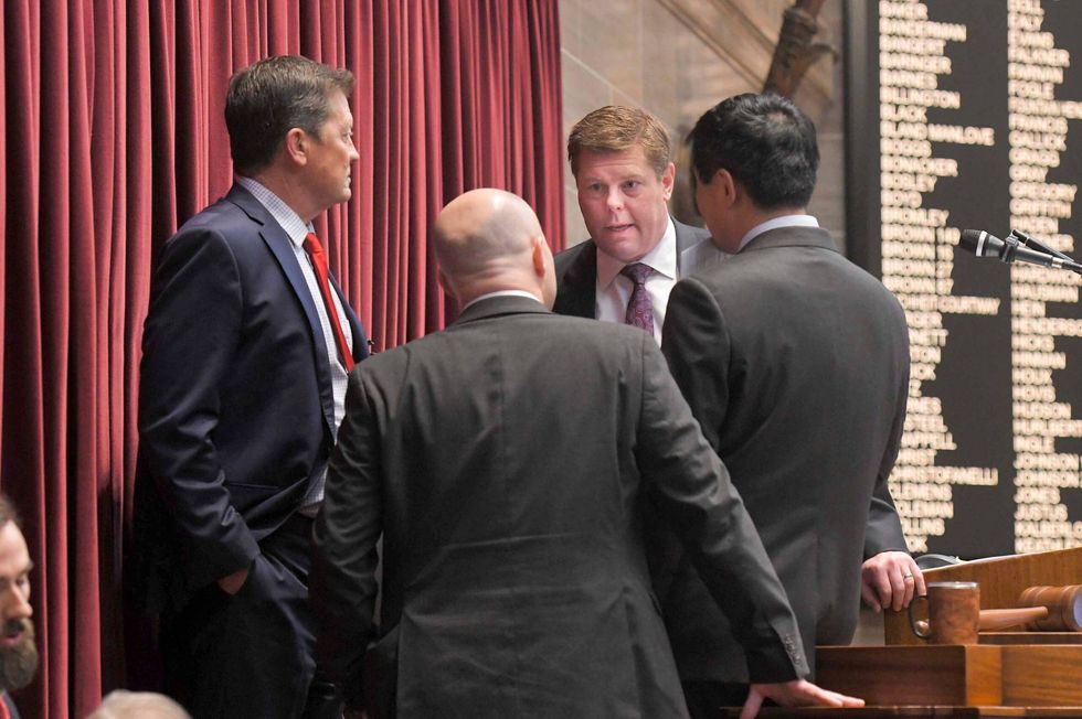 House Speaker Dean Plocher, R-Des Peres, center, speaks with, from left, Speaker Pro tem Mike Henderson, R-Bonne Terre, Budget Committee Chairman Cody Smith, R-Carthage, and Majority Leader Jonathan Patterson, R-Lees Summit, during a March debate on the state budget on March 30, 2023.
