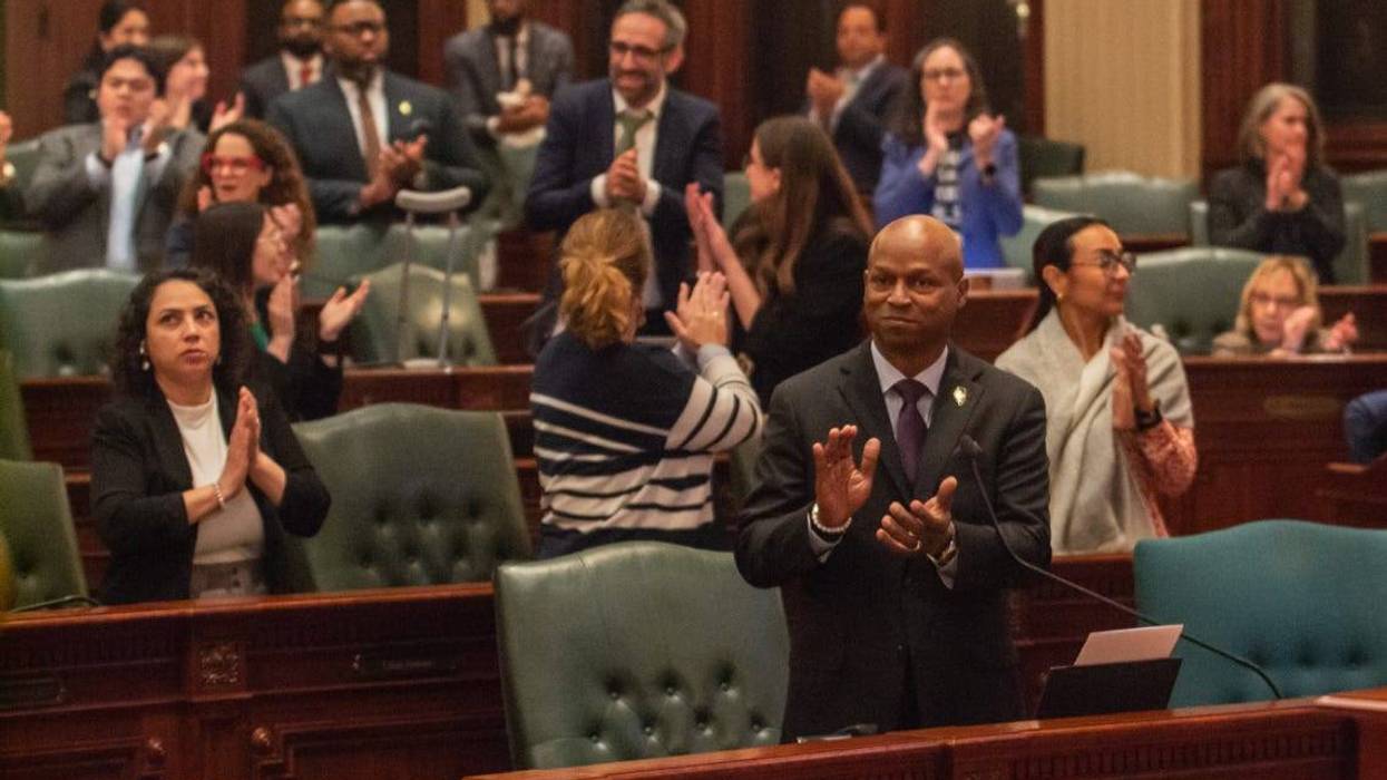 House Speaker Emanuel “Chris” Welch and members of his Democratic caucus applaud members of their staff early Sunday morning after the chamber approved the $55.2 billion budget bill.